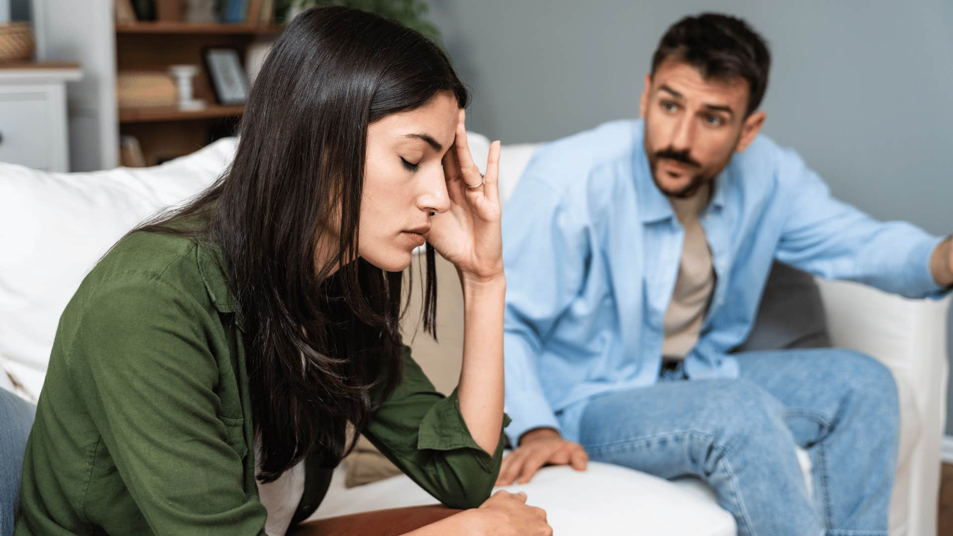 man arguing with woman while woman looks done 