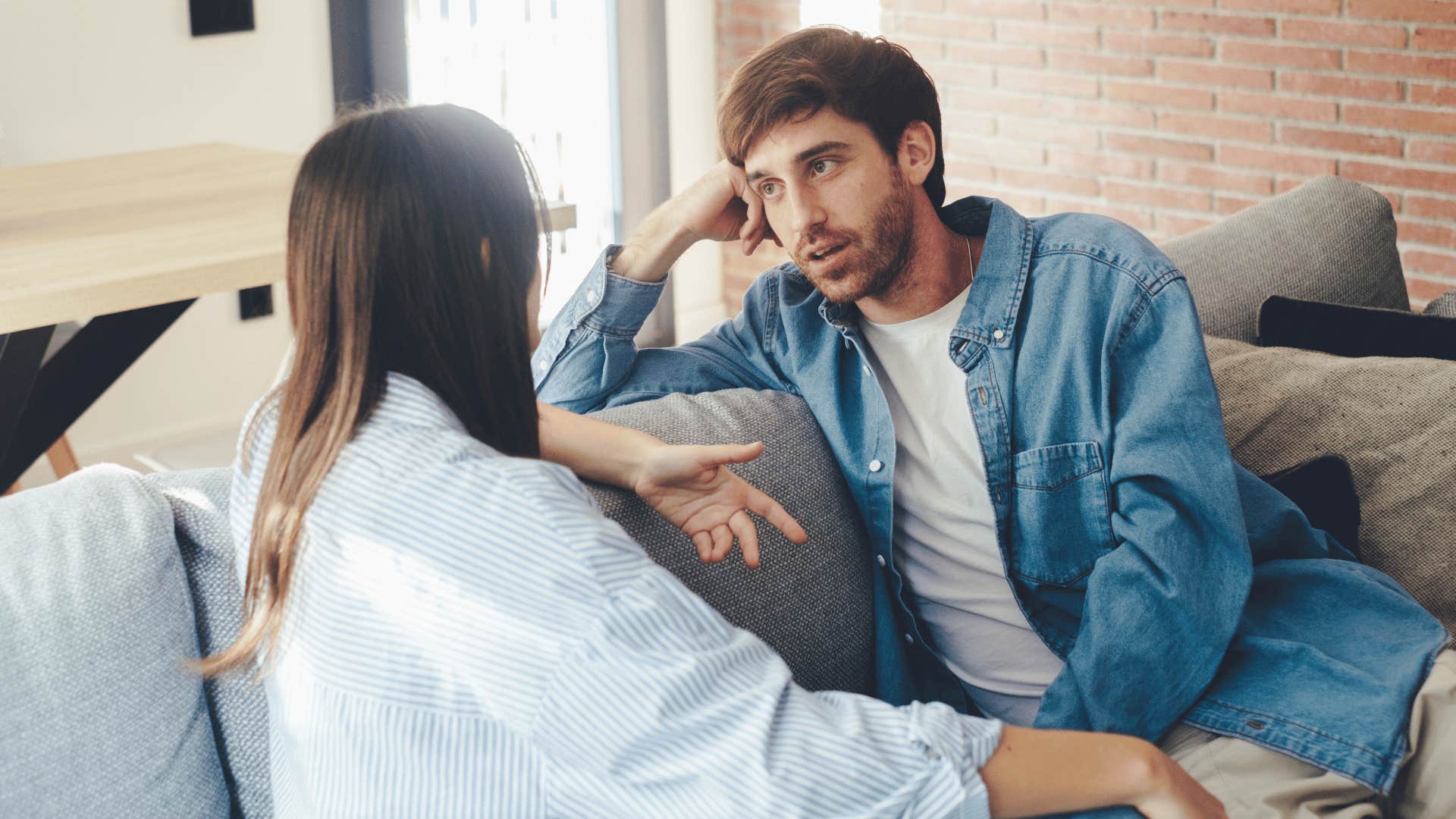 man and woman taking on couch