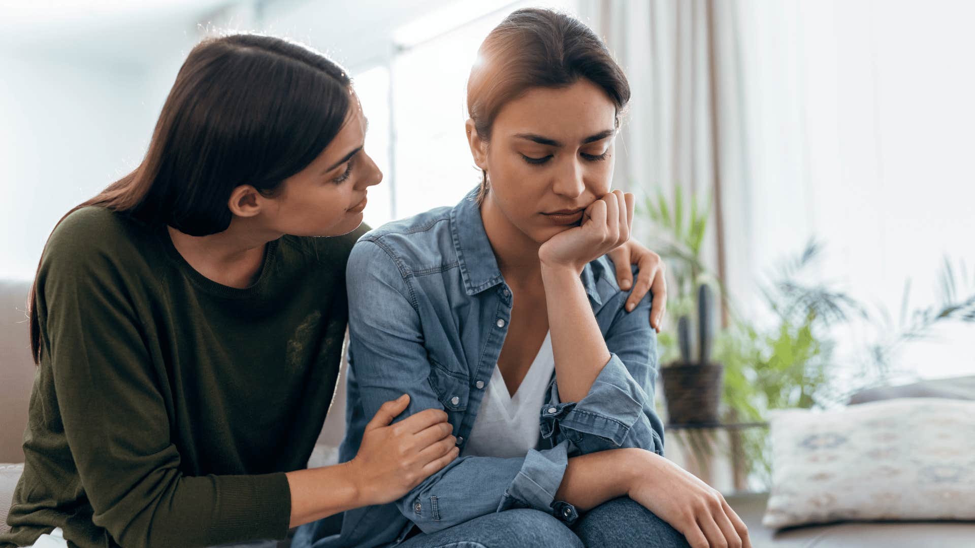 woman comforting another woman