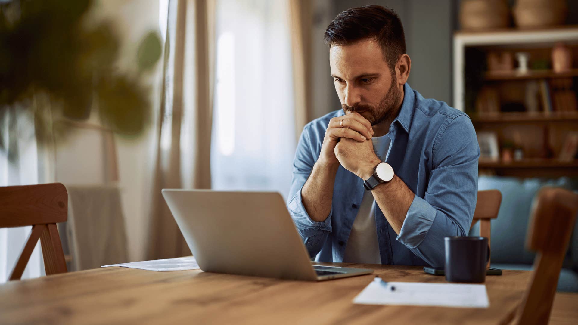 man staring at laptop