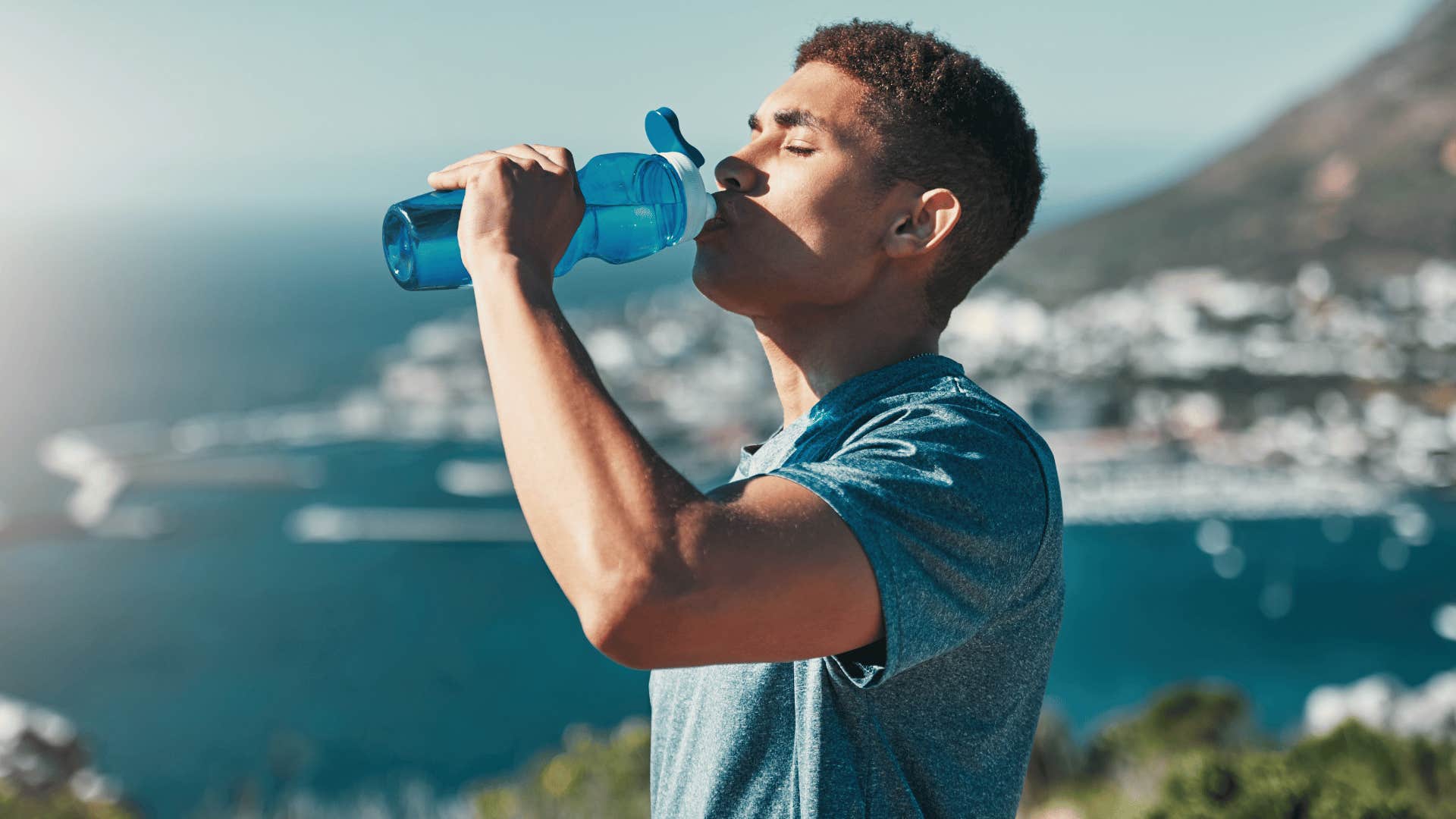 man drinking water after going on a hike