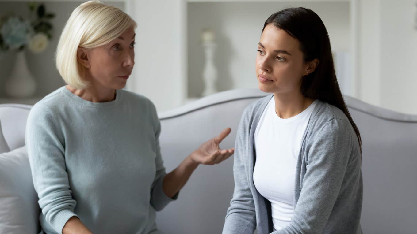 serious parent talking down to daughter