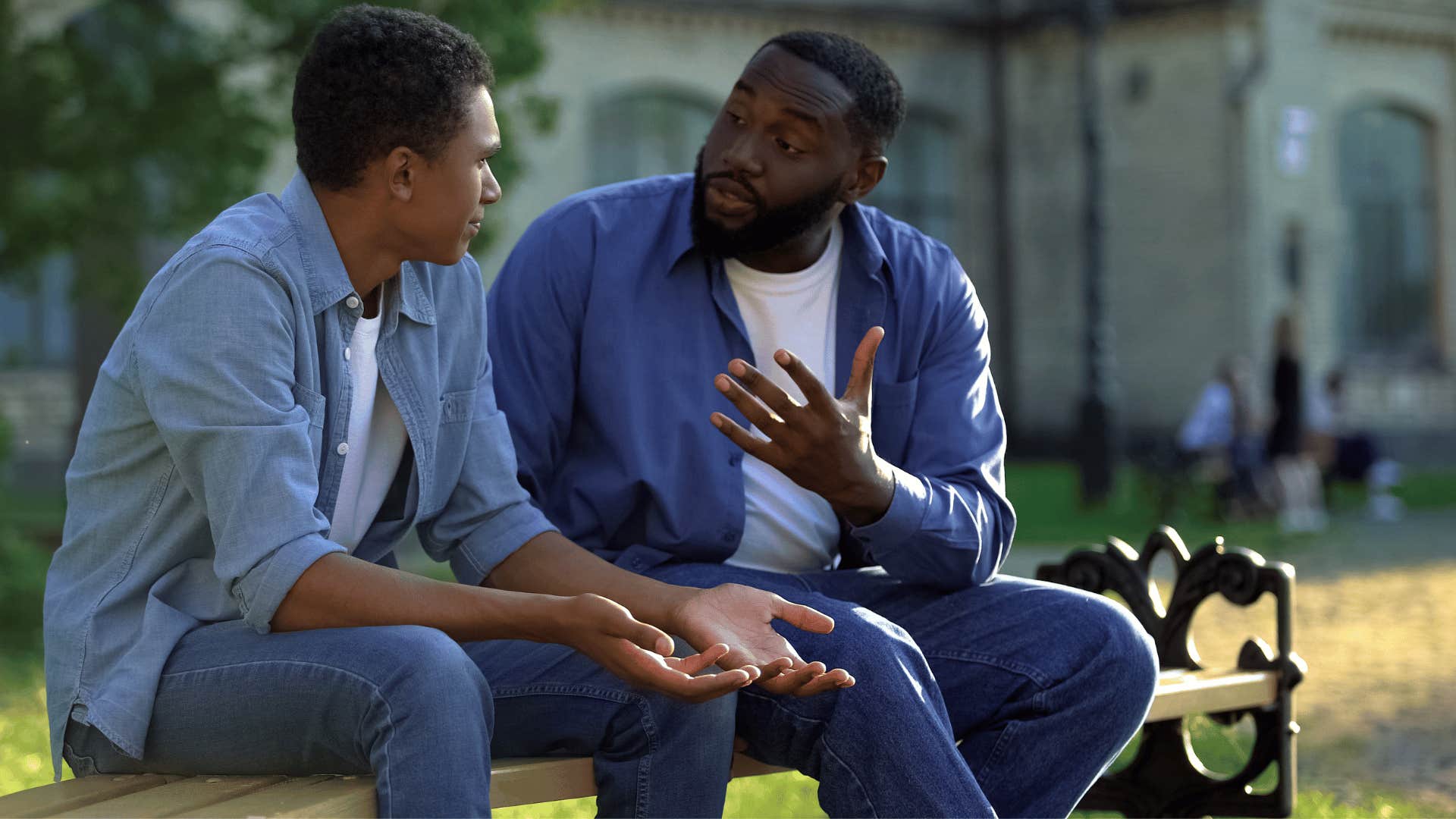 father and son talking on bench