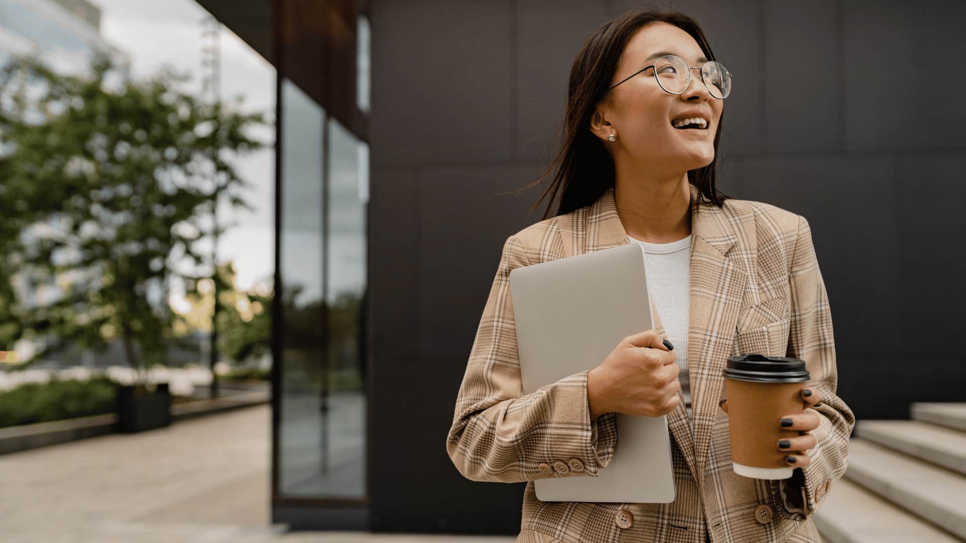 woman smiling outside office building