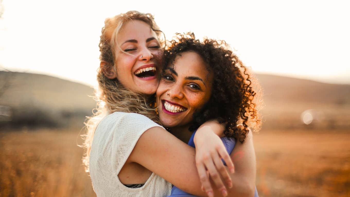 two happy friends hugging