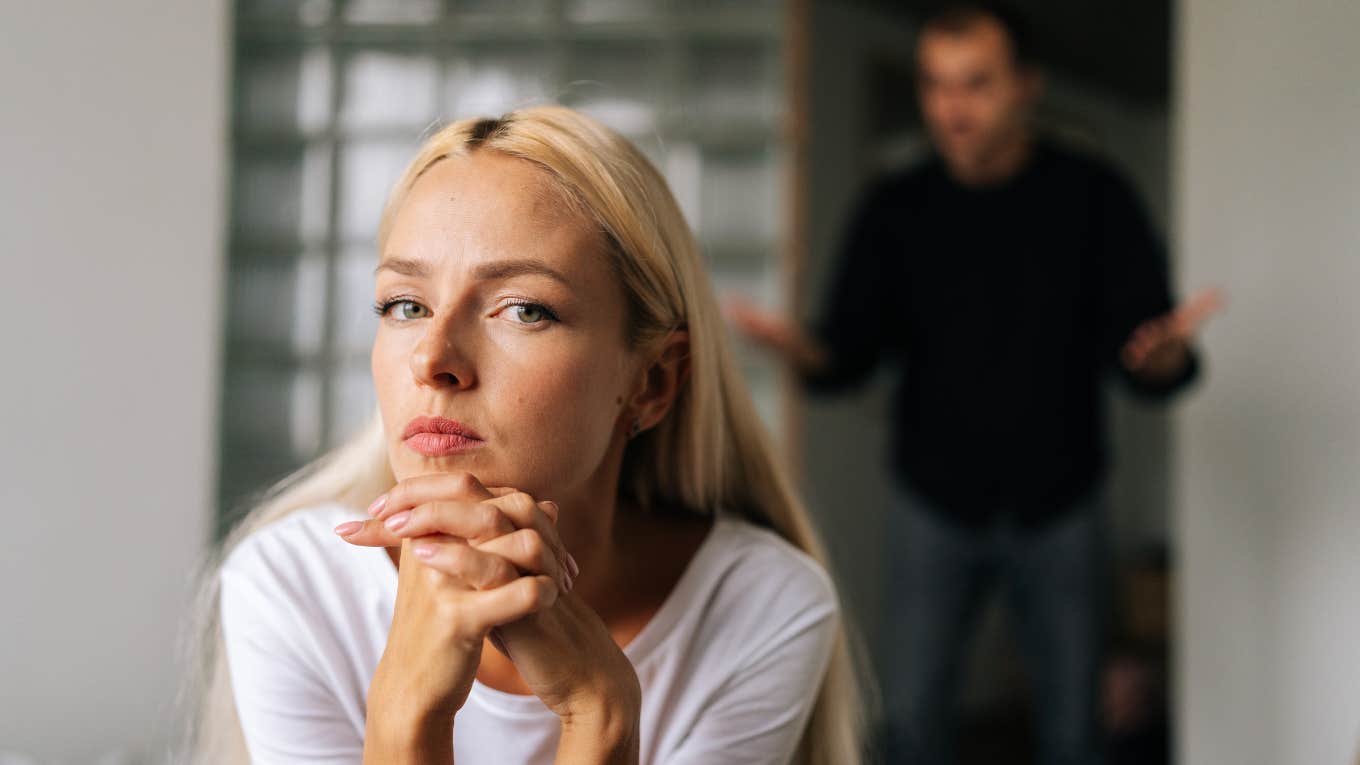 woman thinking with man in the background