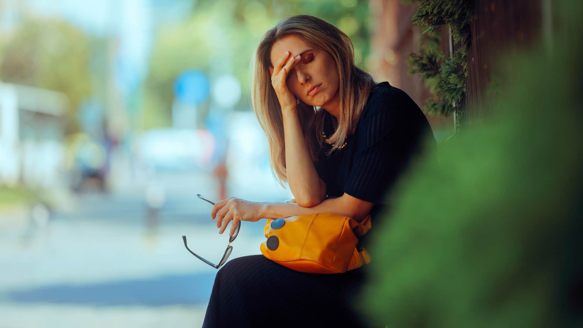 Stressed Woman Suffering a Headache Resting Outdoors