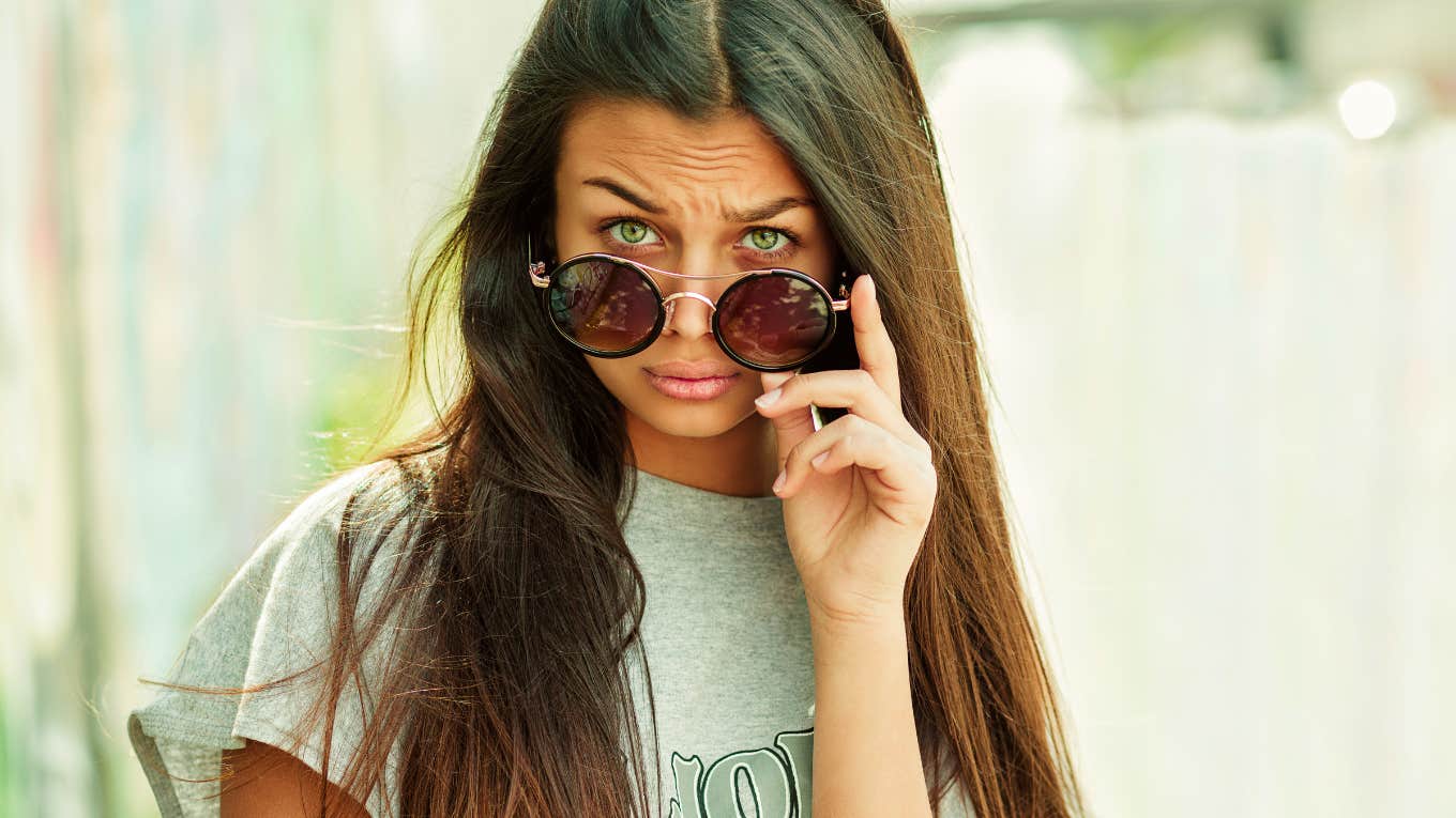 woman who raised in a judgmental home looking at the camera judgmentally