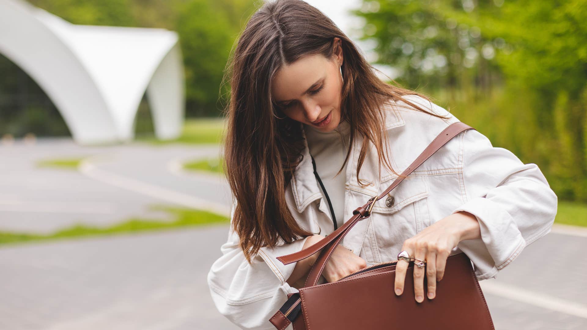 Woman looking through her purse in public.