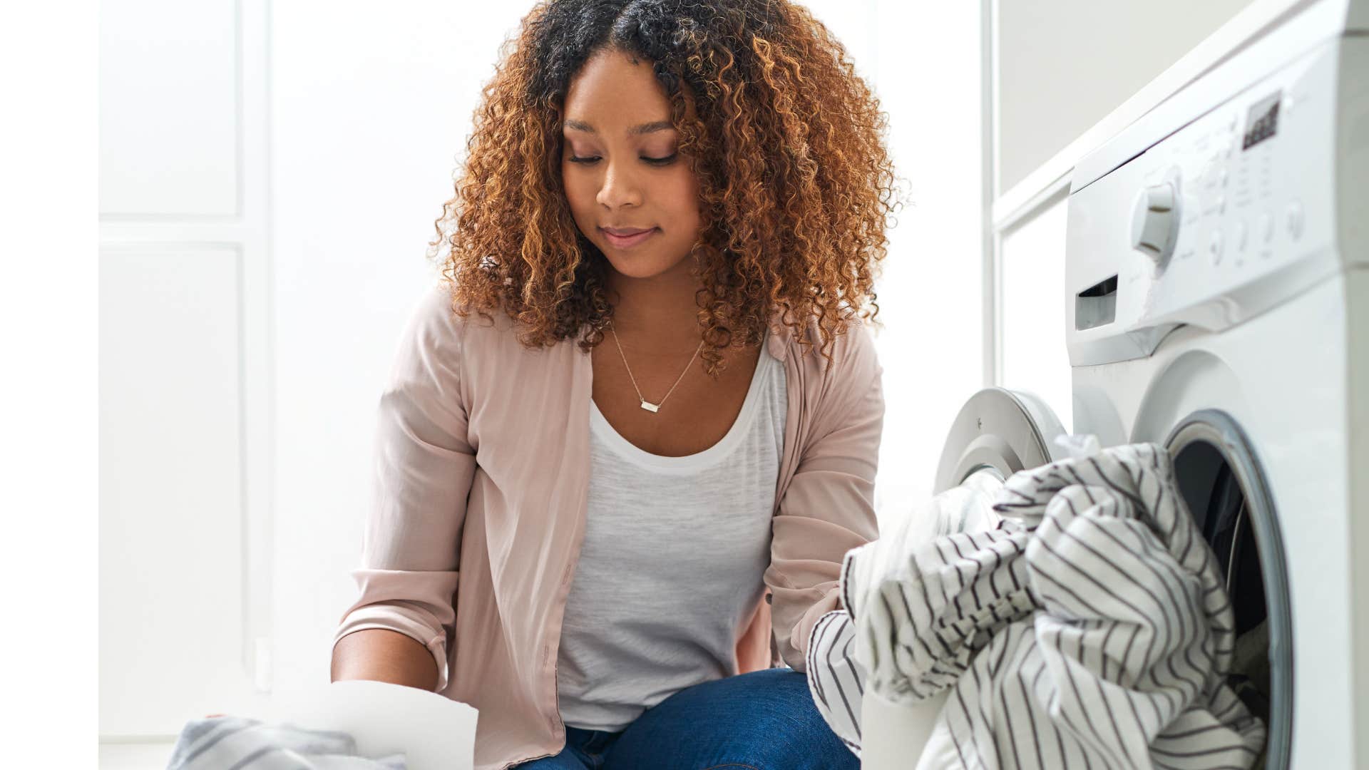 Woman doing her laundry at home.