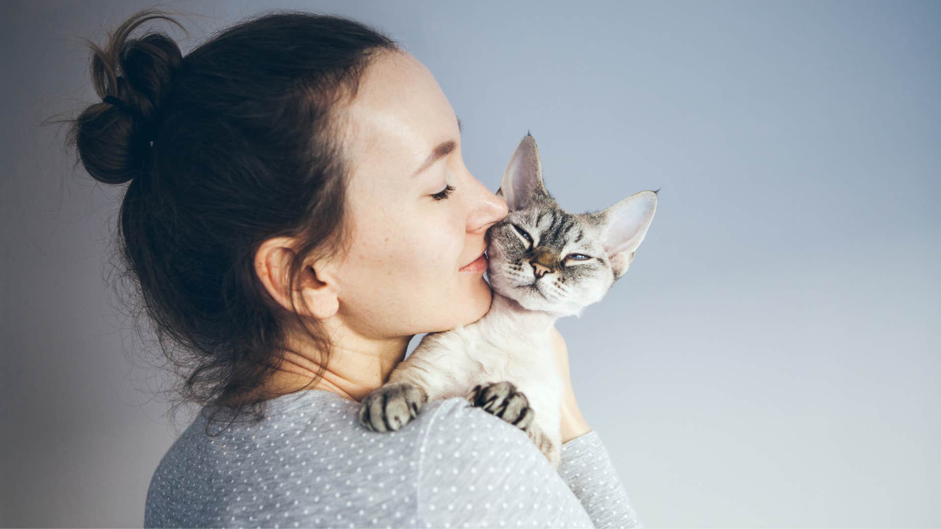 empathic woman connecting with pet cat