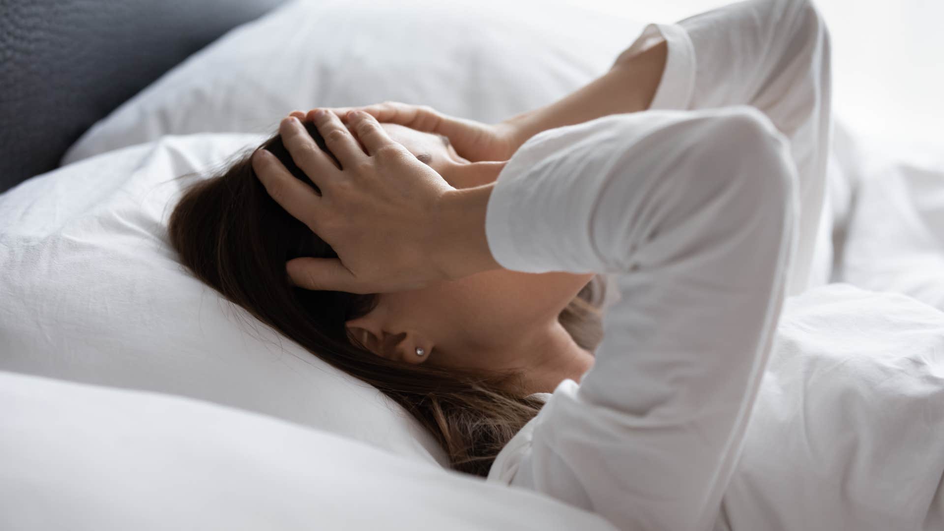 woman feeling drained laying in bed