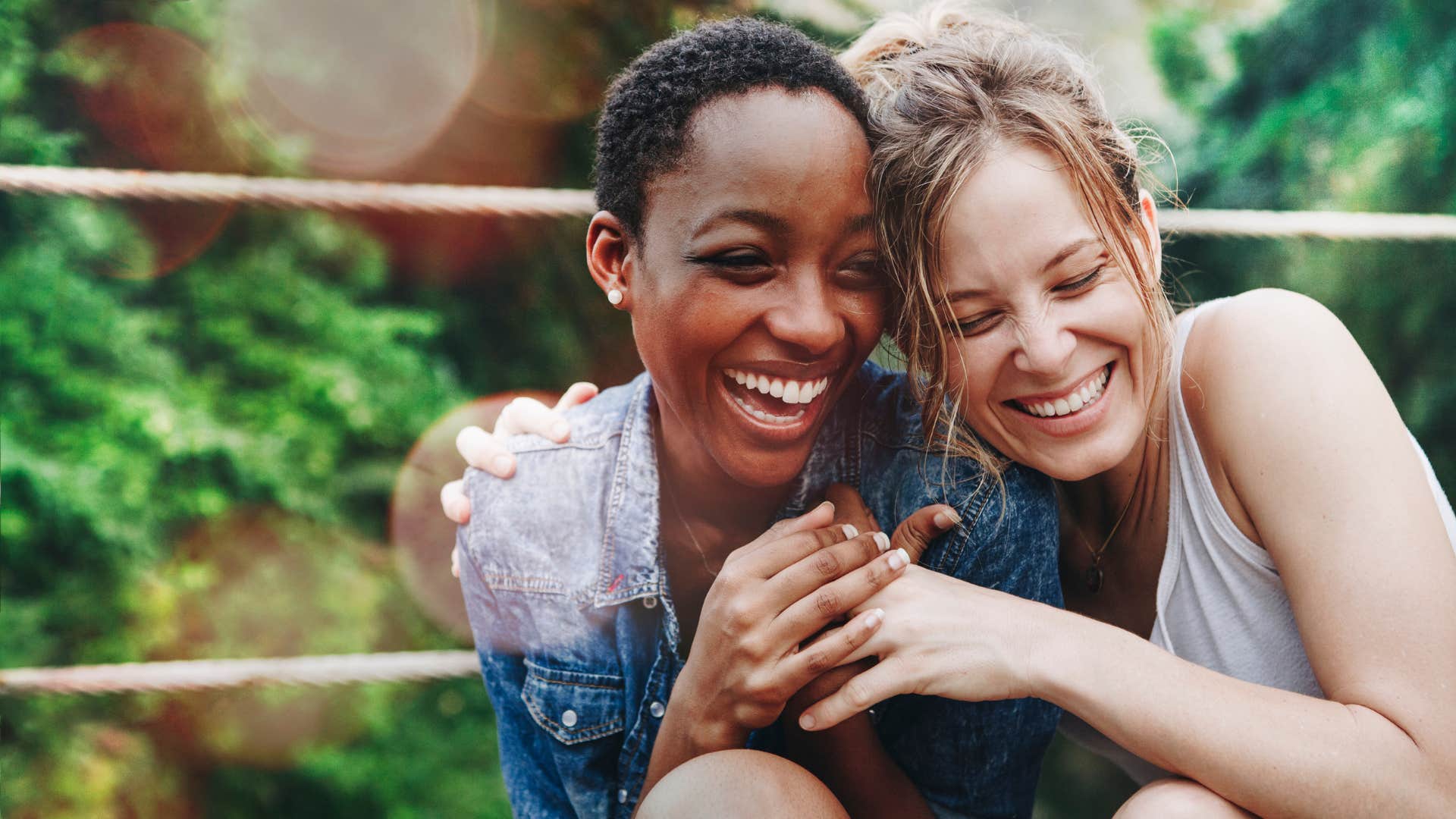 two women with healthy relationship hugging