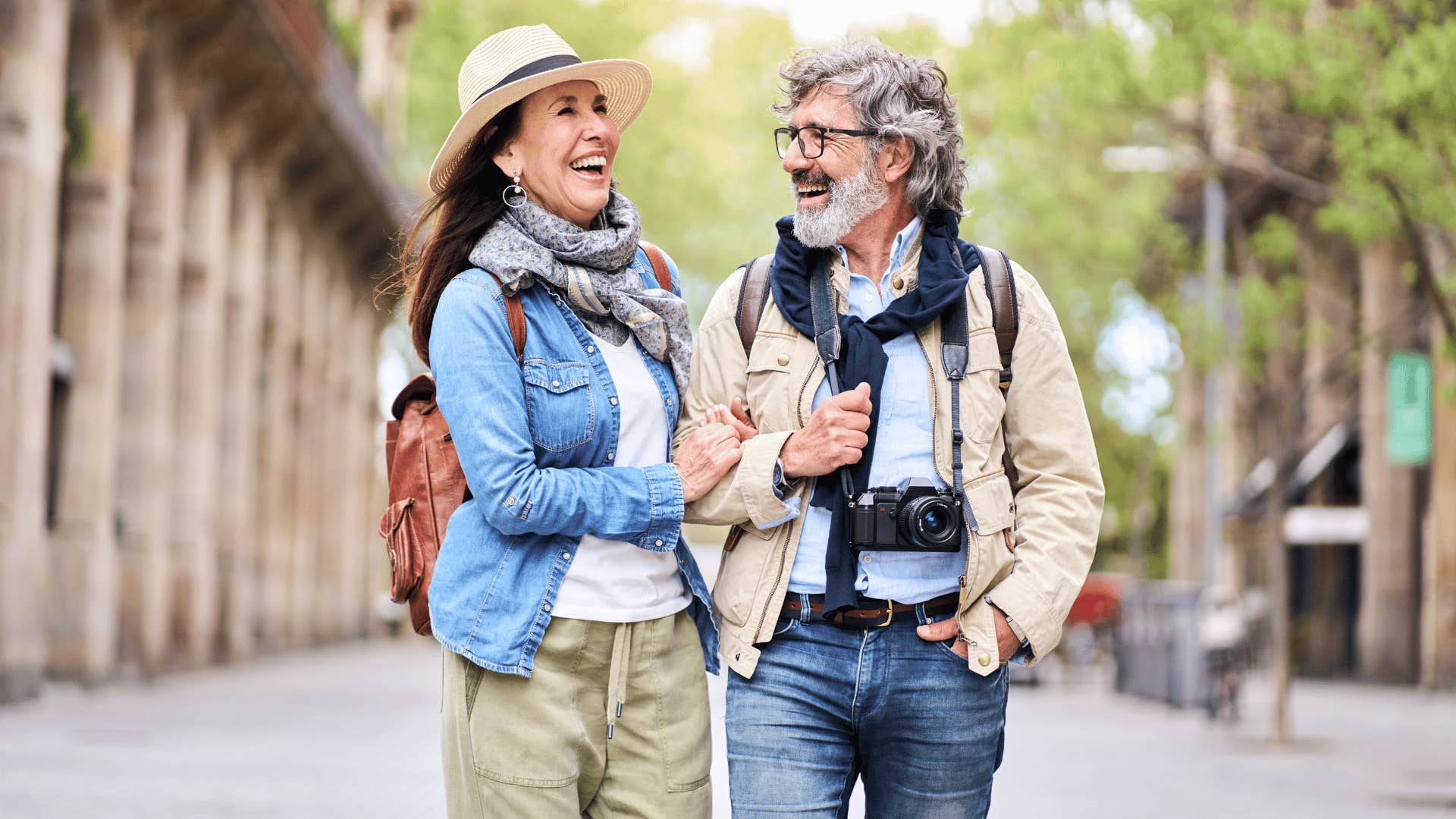 Couple wlaks arm in arm down sidewalk