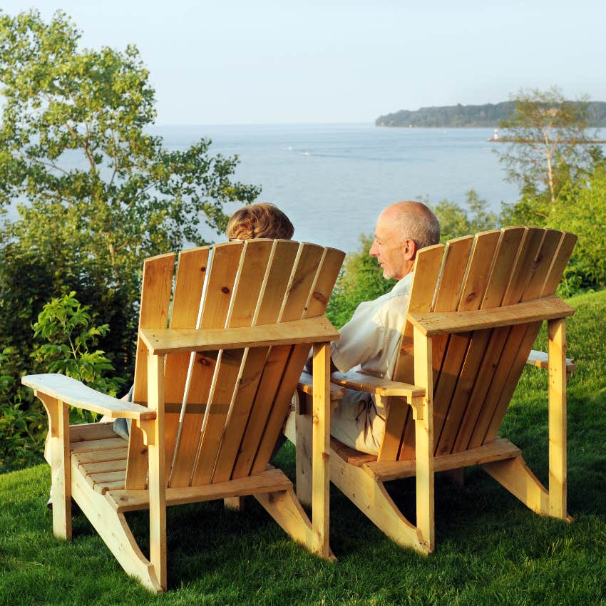 Couple sitting in Adirondack chairs on a hill