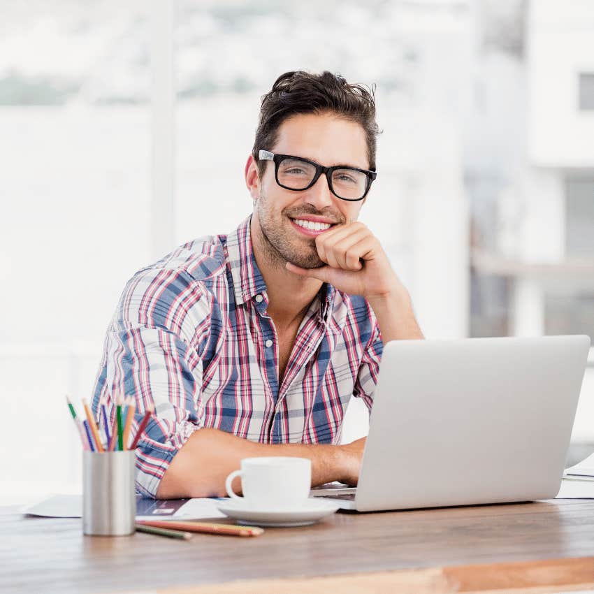 smiling man sitting at desk