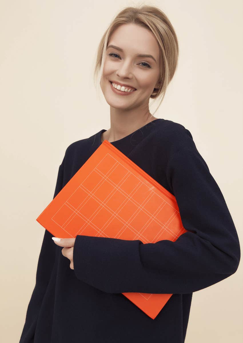 smiling woman holding a folder