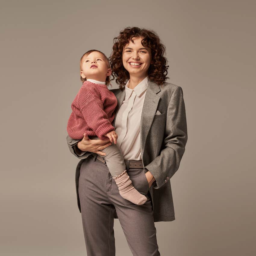 smiling working mom holding a child