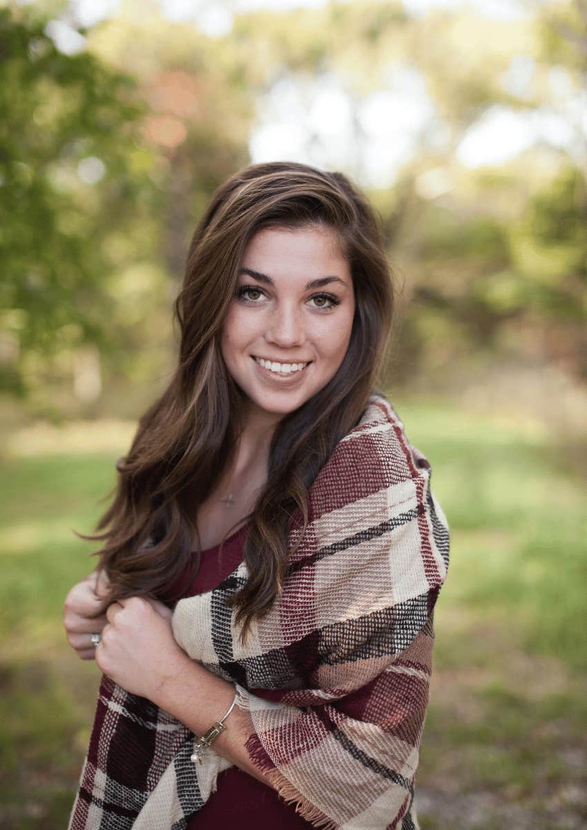 smiling young woman posing outdoors