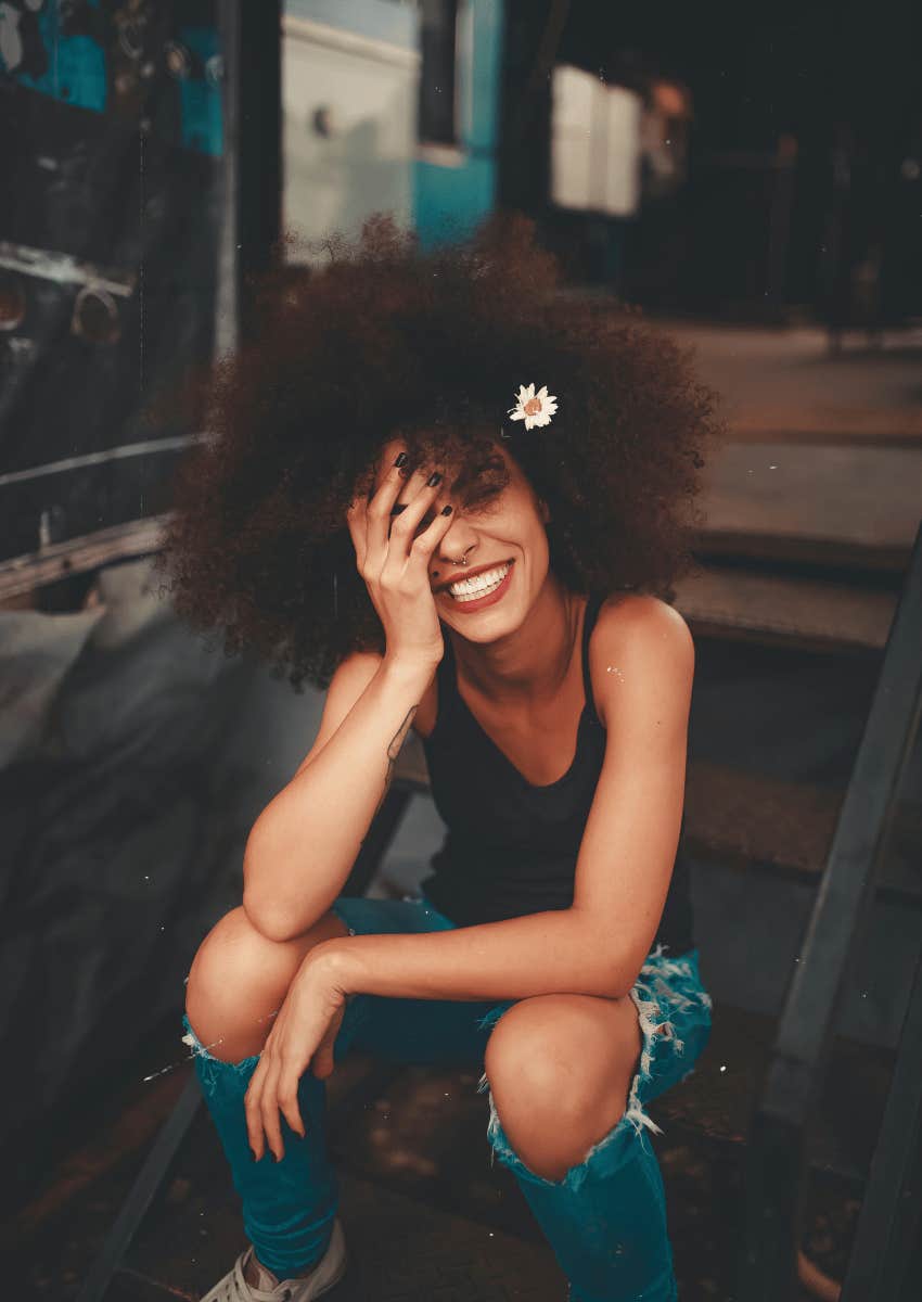 smiling young woman sitting in a low chair