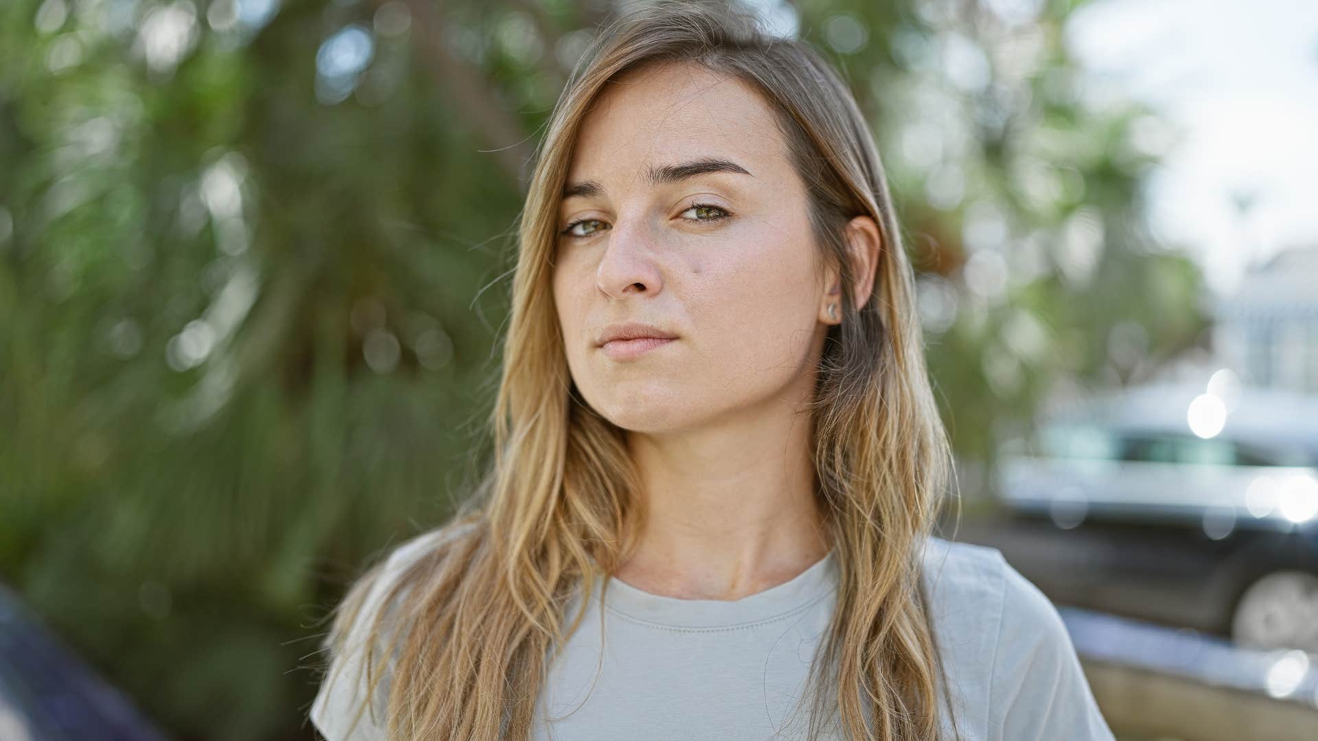 Woman looking solemn outside in nature