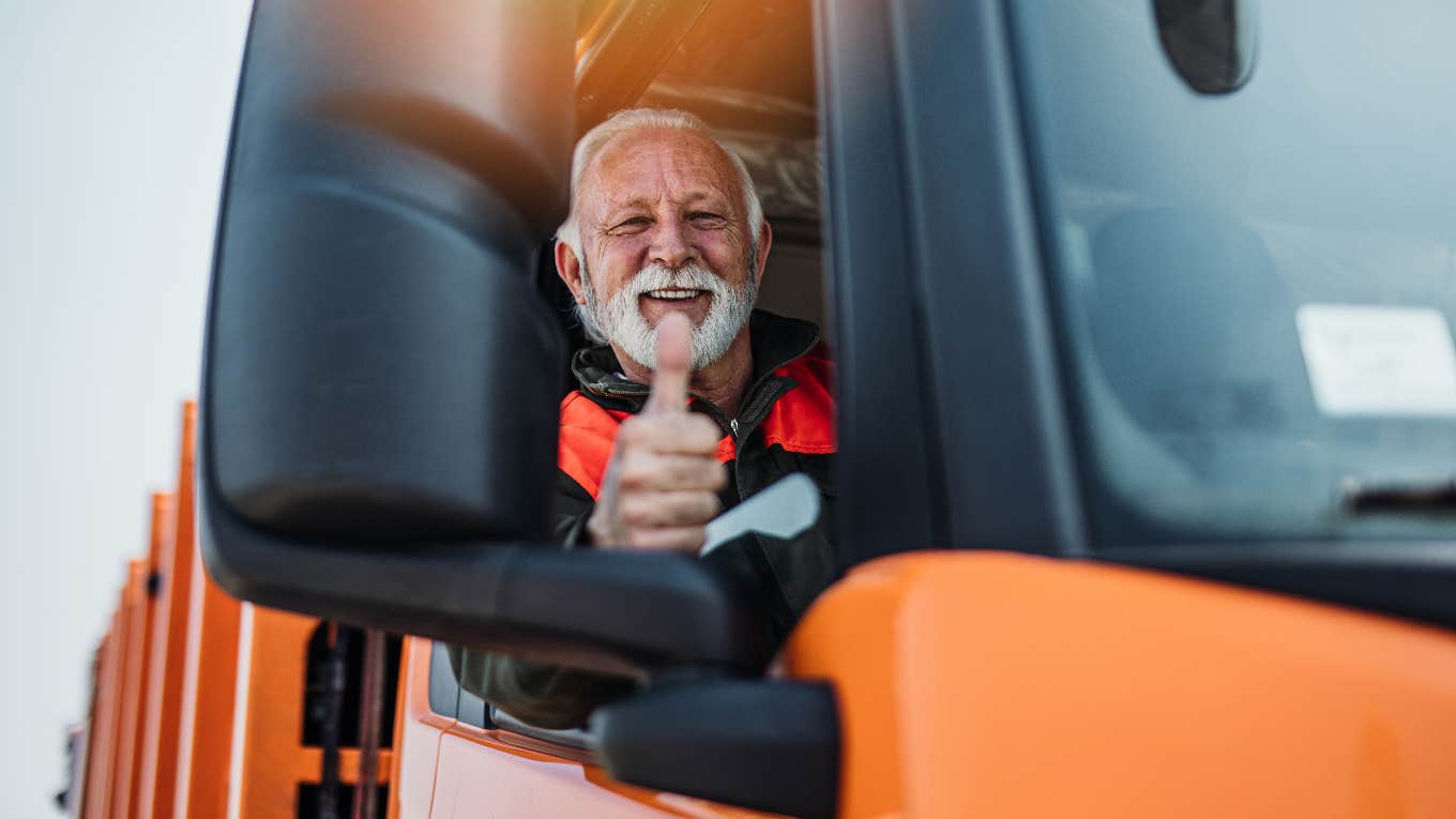 Happy garbage truck driver