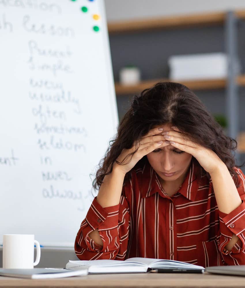 teacher with hands on head feeling stressed