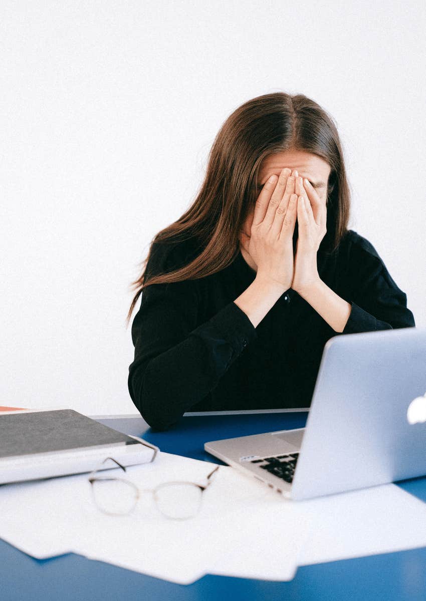 stressed professional woman covering her face