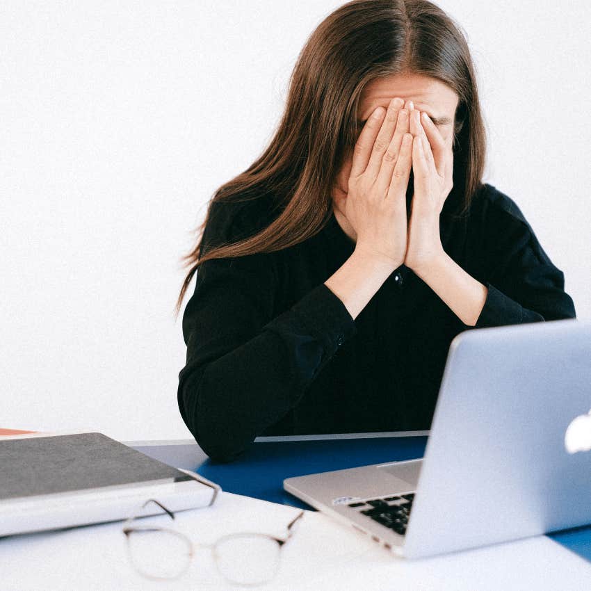 stressed woman covering her face