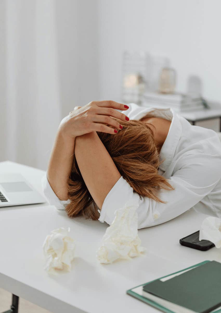 stressed woman resting her head on the table