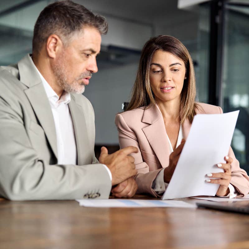 business woman and man consulting documents in office