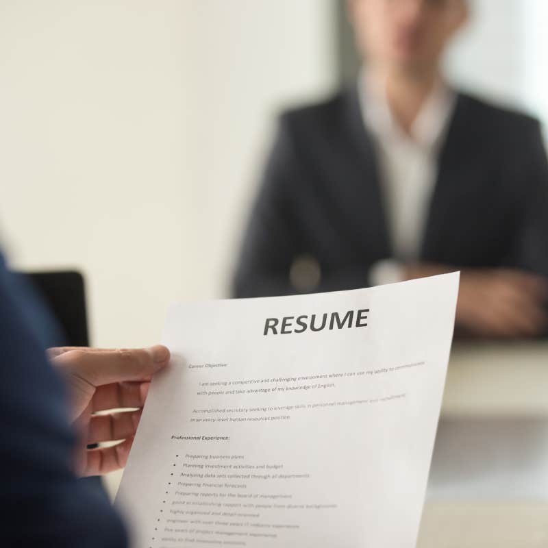 close up shot of man holding resume