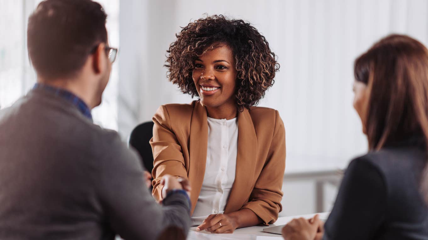 hiring managers shaking woman's hand during job interview