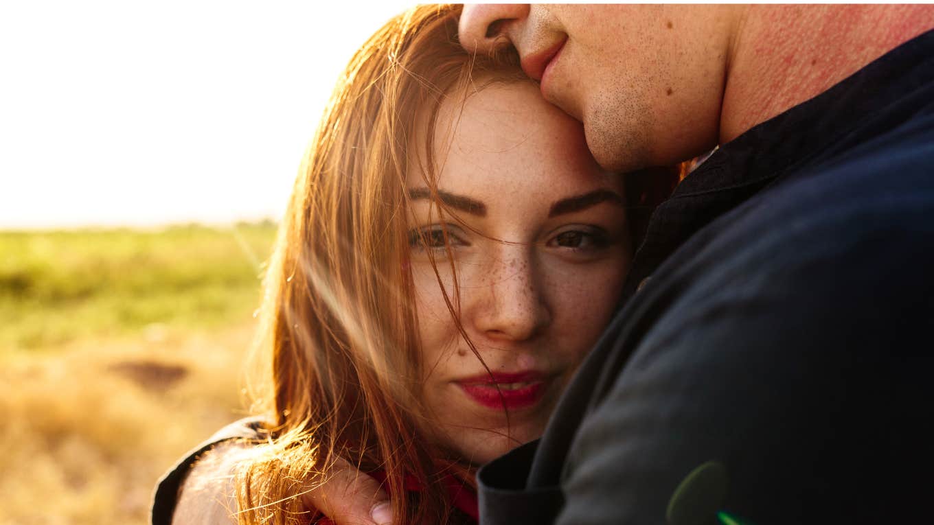 couple holding each other with woman thinking about breaking up