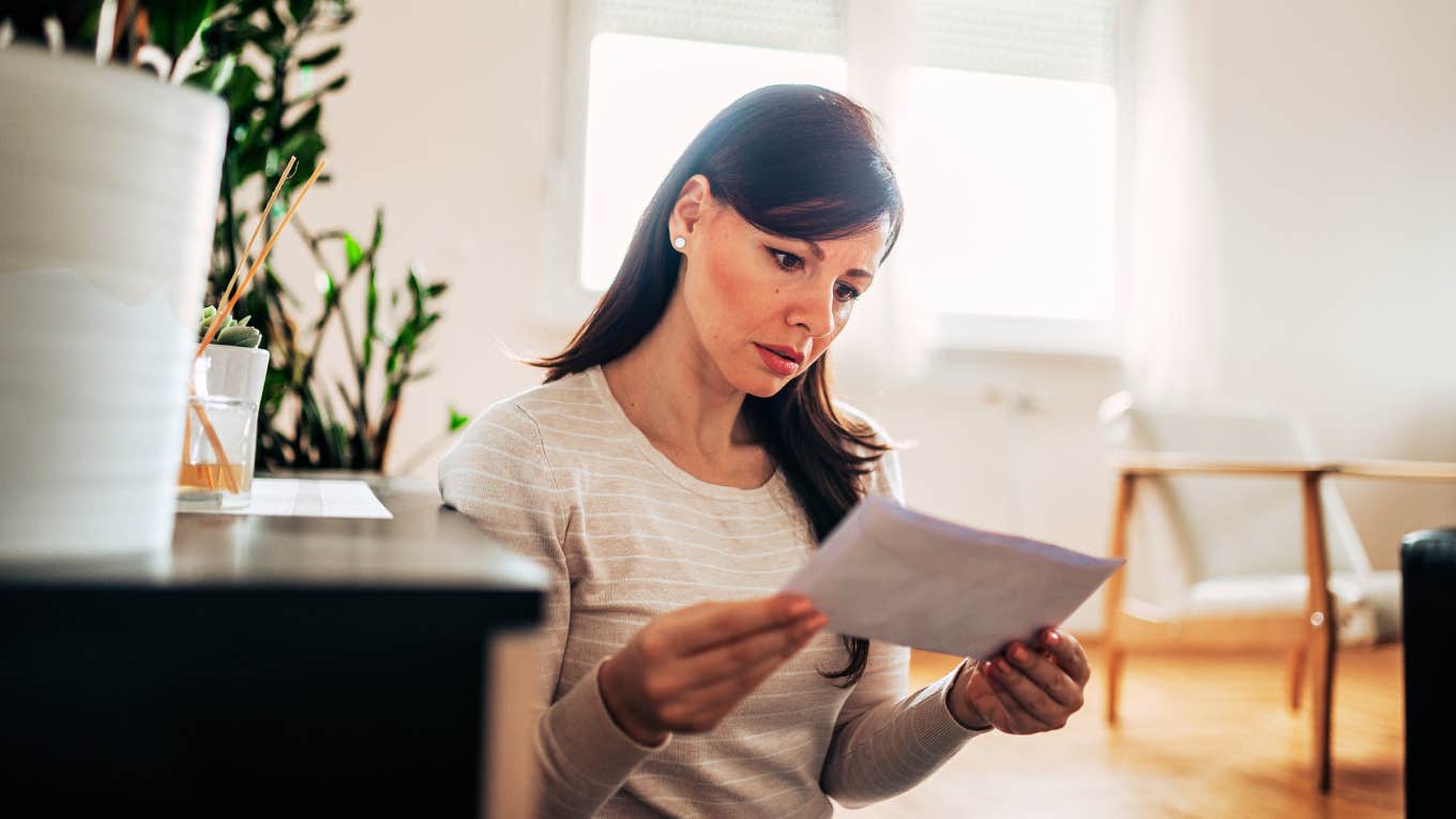 Woman opening bill, finding out that man is financially cheating on you.