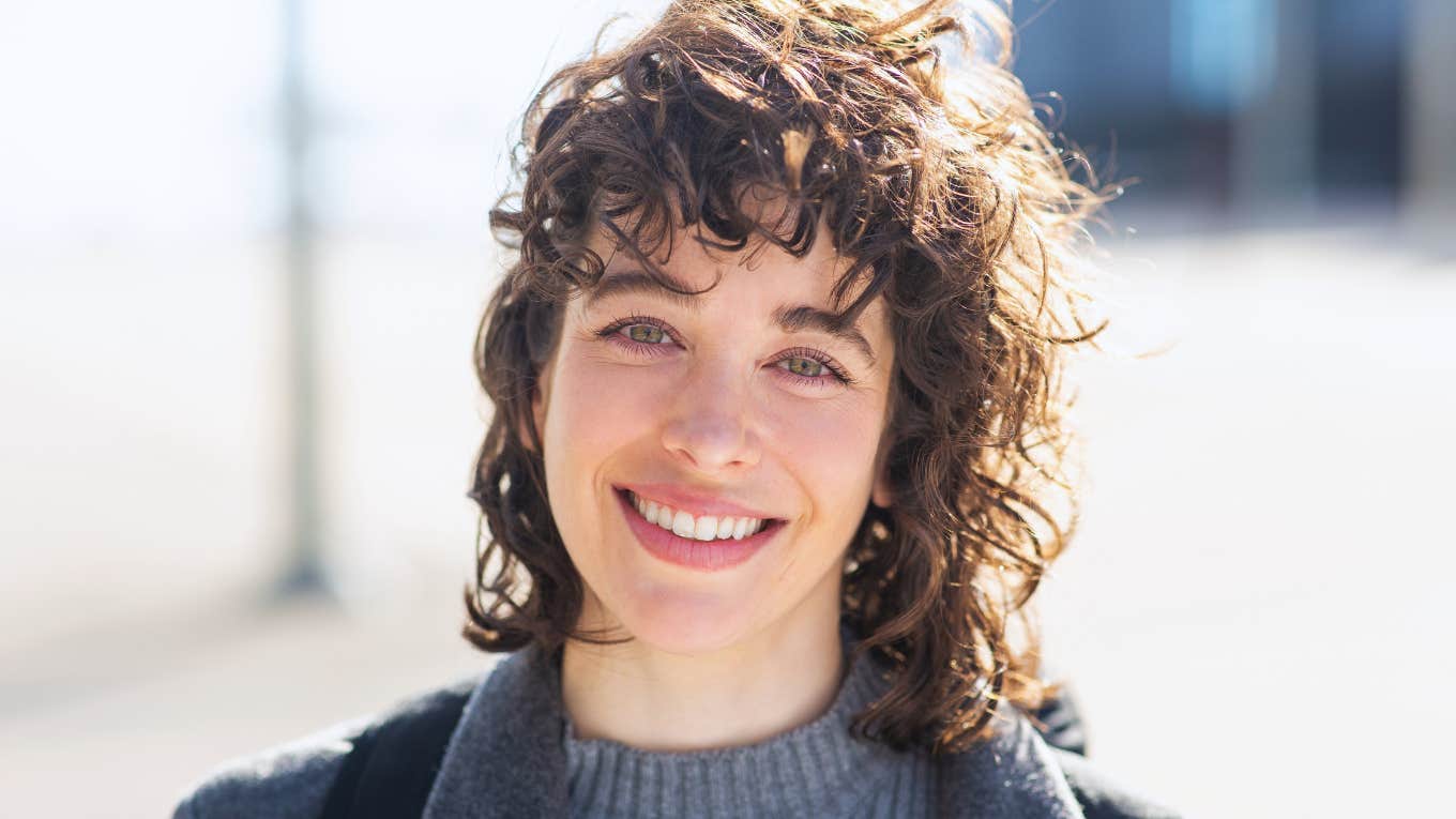 smiling intelligent woman standing outside