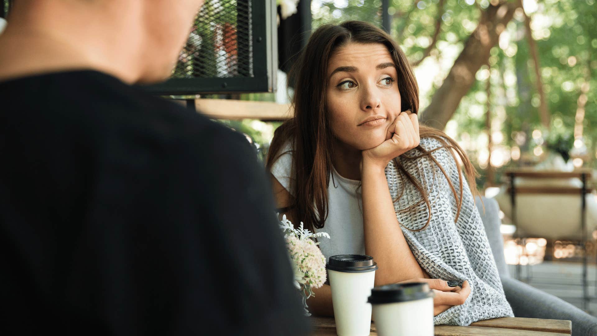 woman looking annoyed on coffee date