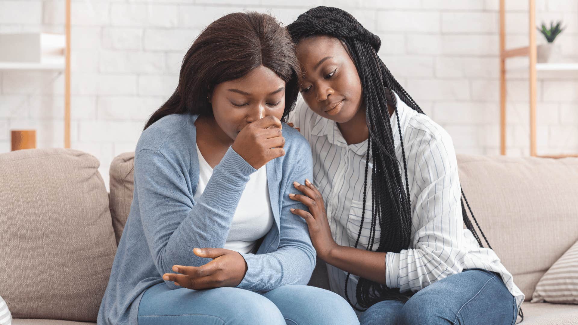 woman comforting another woman