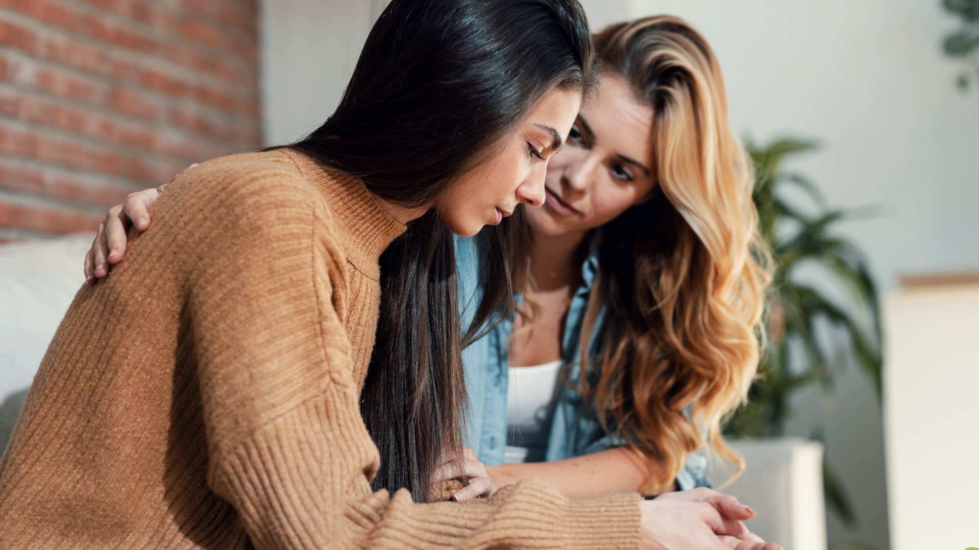 Woman comforting woman with toxic coping mechanisms