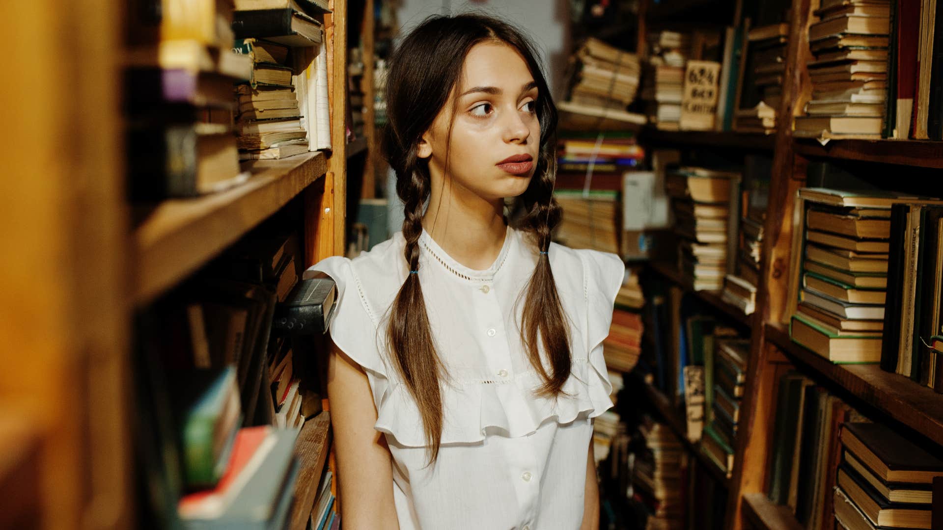 Woman looking around in a library.