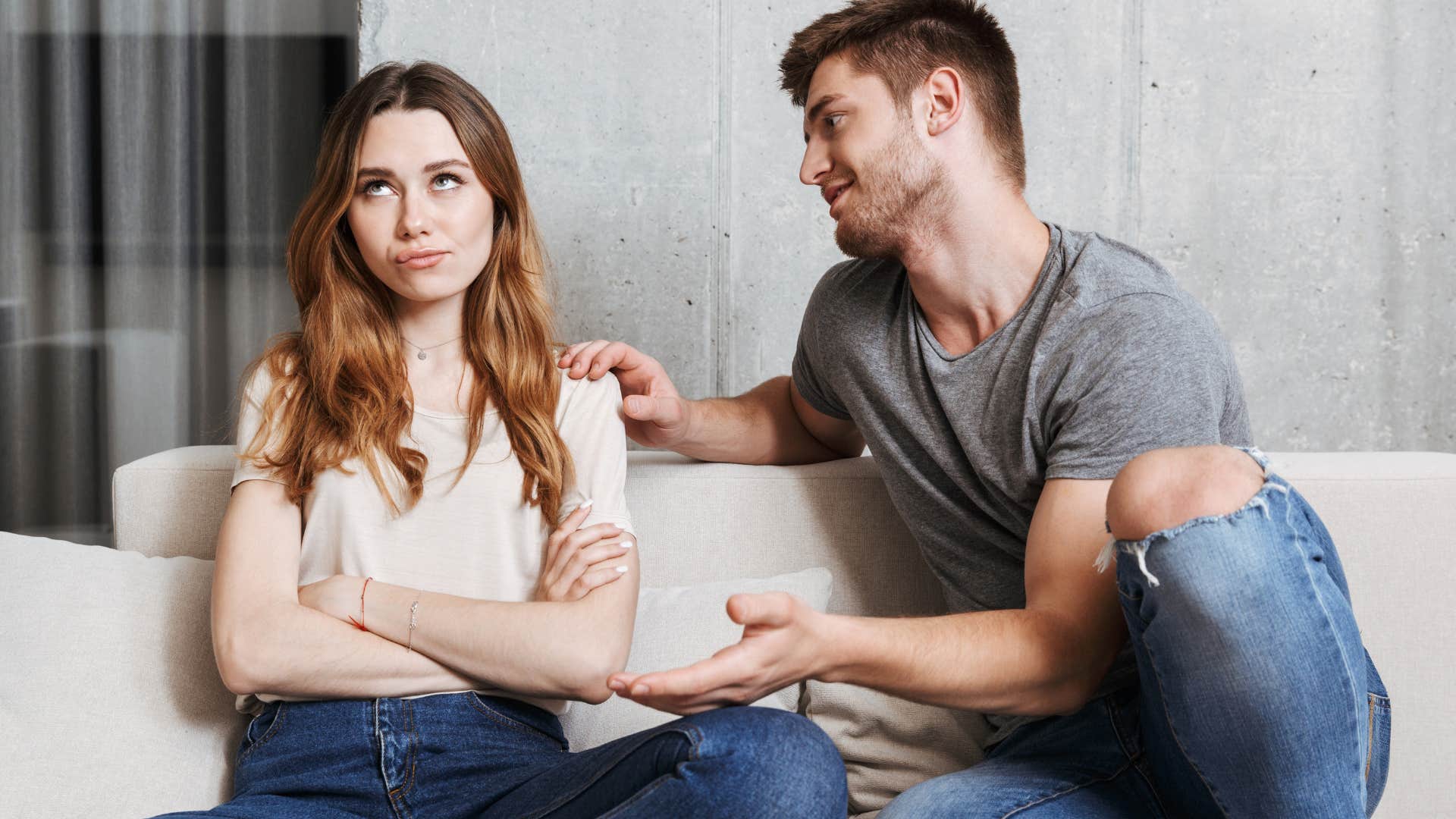 Couple arguing on their couch.