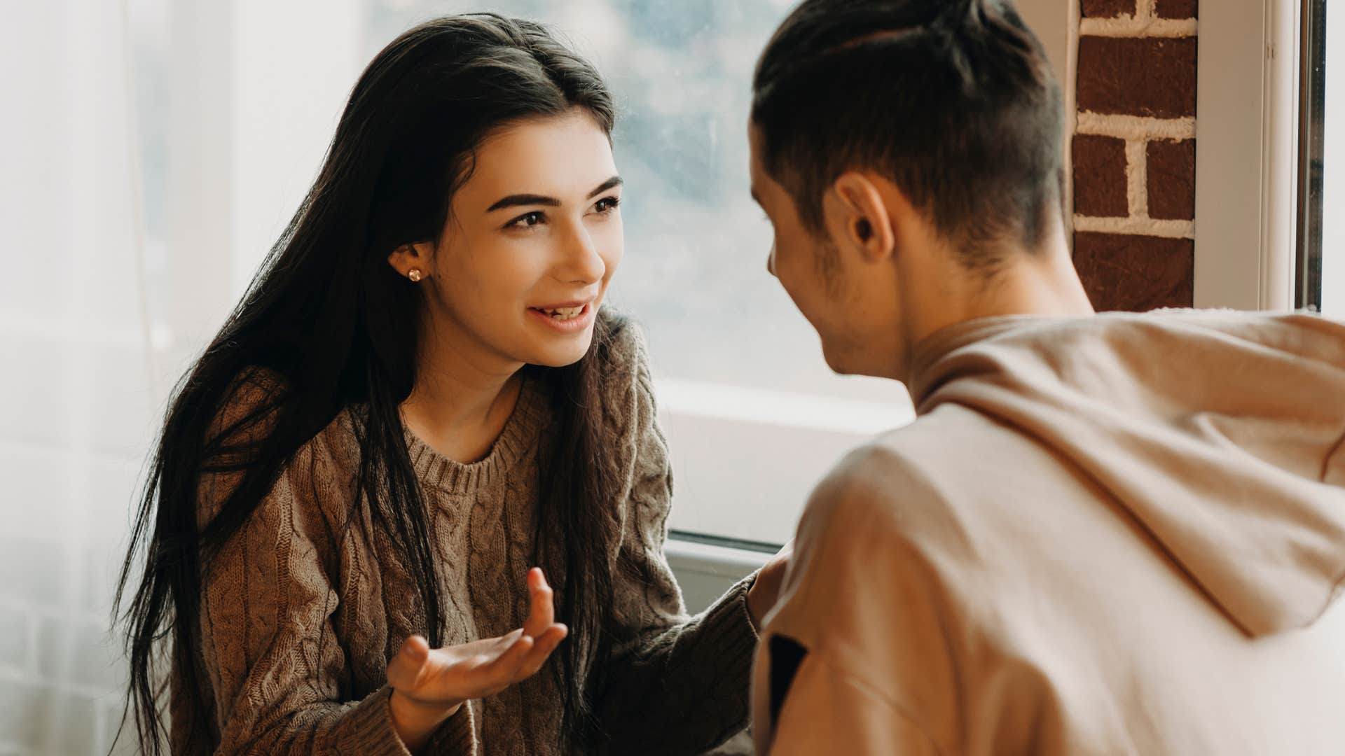 Woman looking happily at her partner during a conversation. 