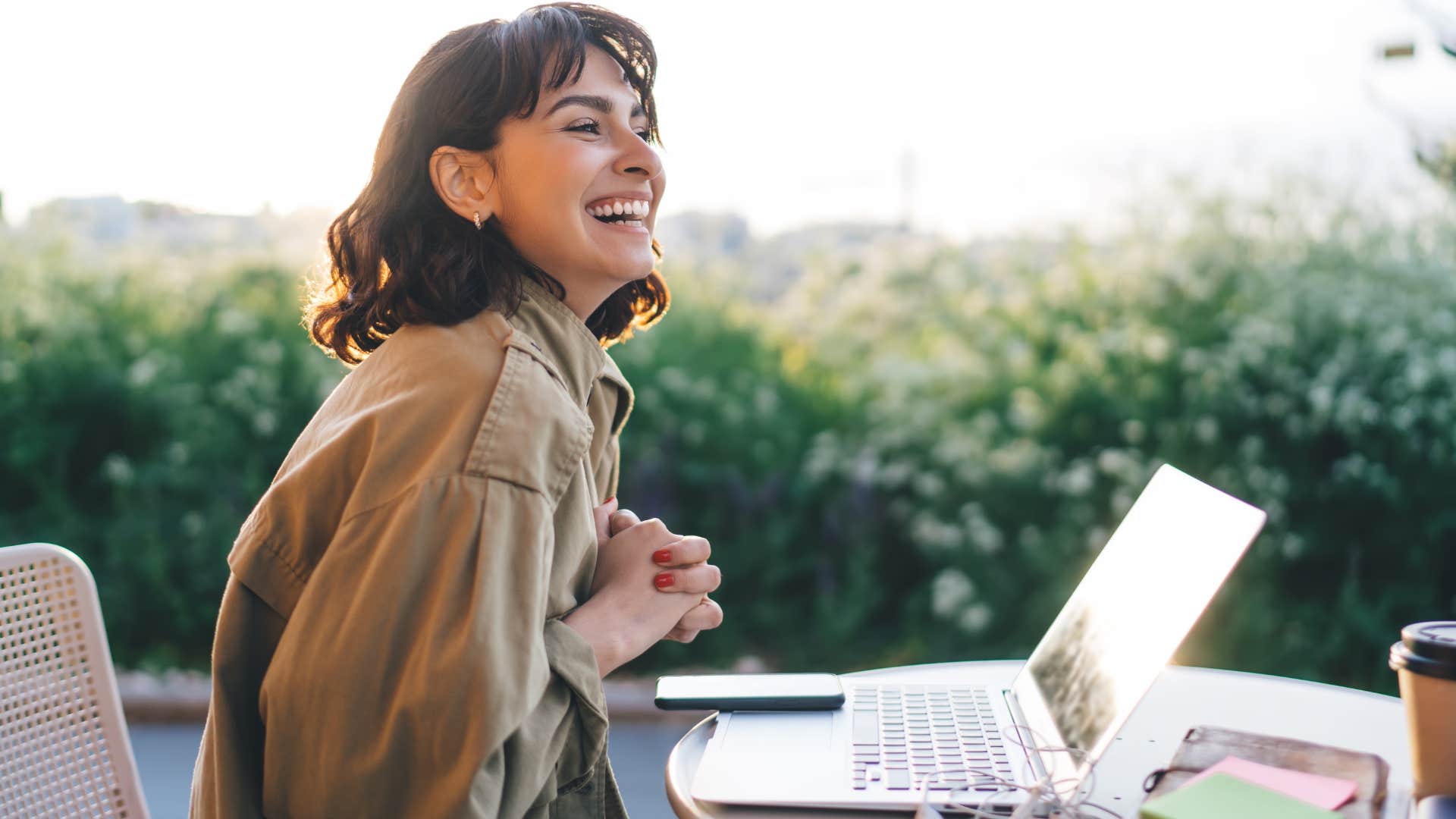 Woman looking happy and independent on her laptop.