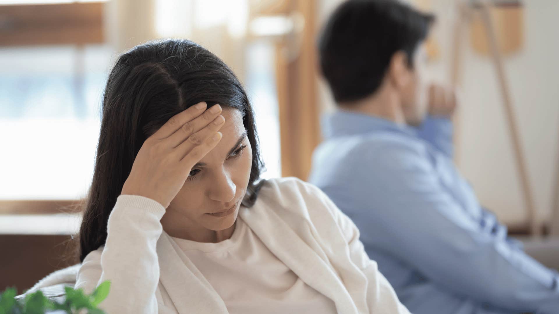 woman looking frustrated while man turns the other way