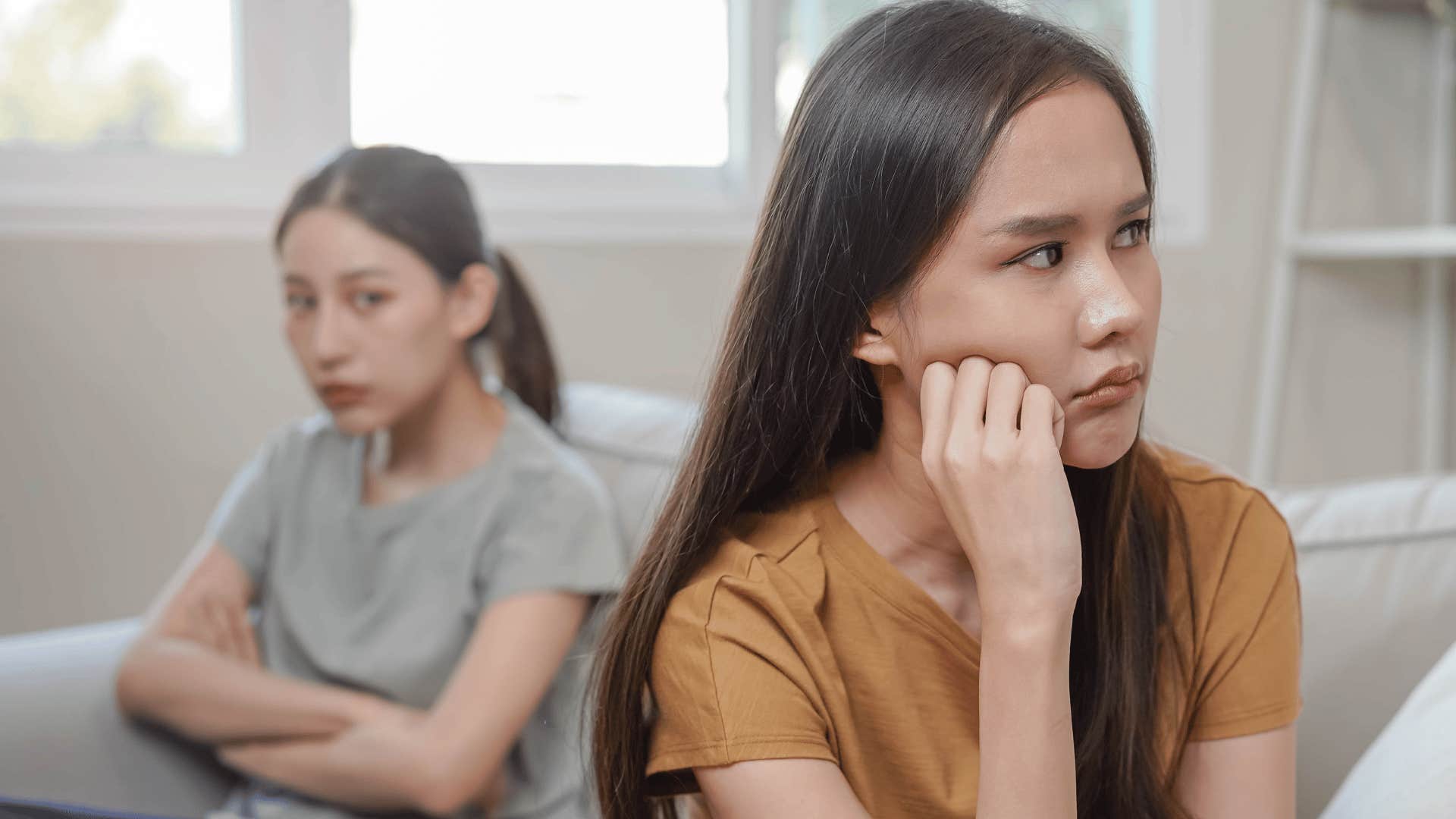 two sad women sitting together