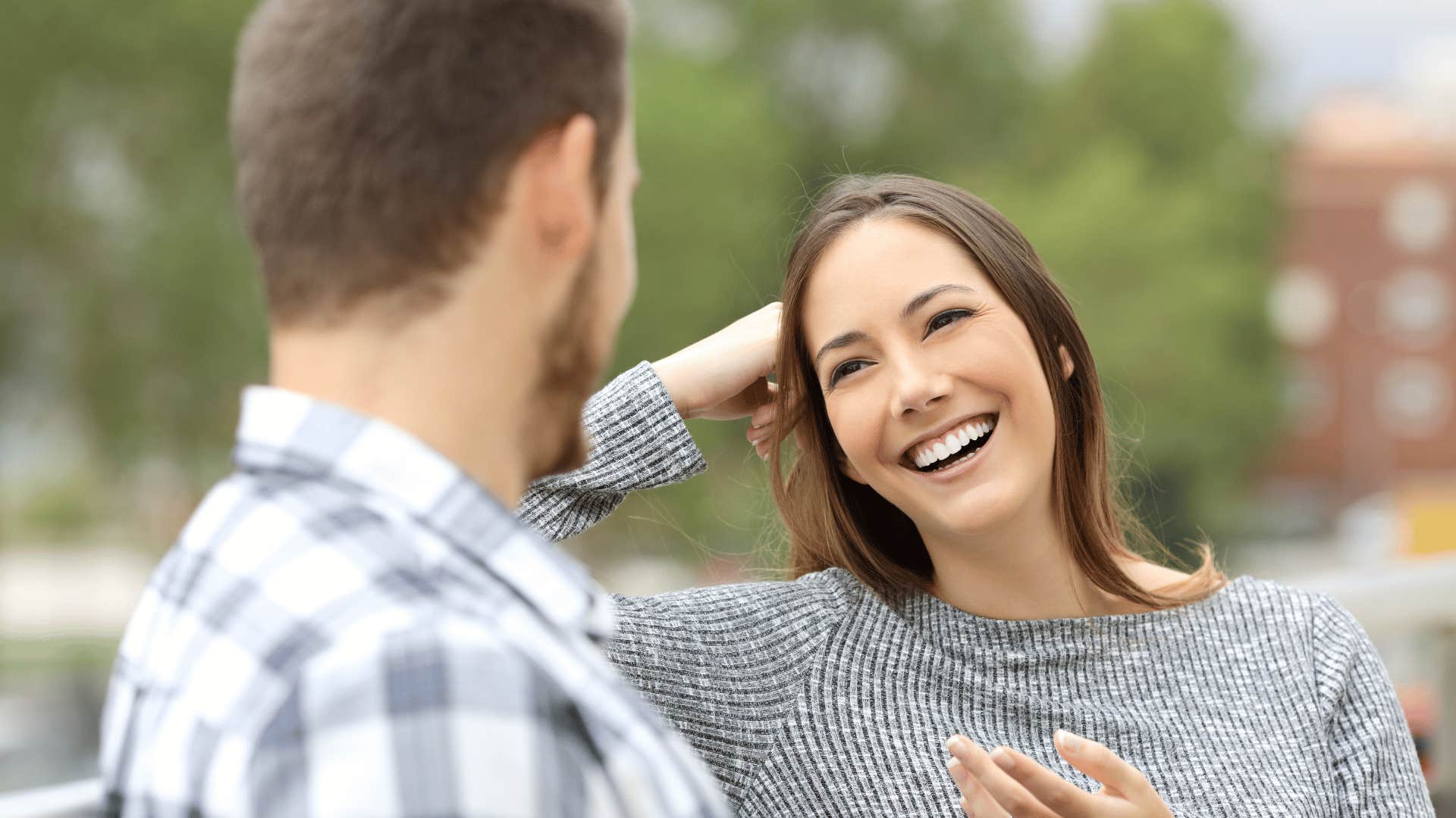 smiling woman talking to man