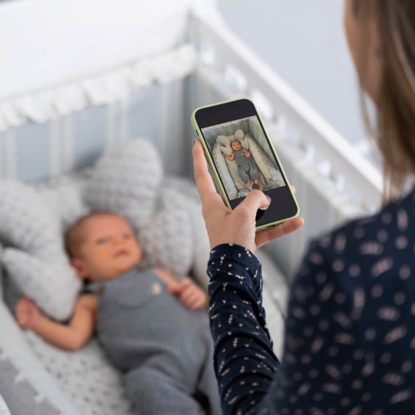 Mom taking a photo of her baby to send to grandma