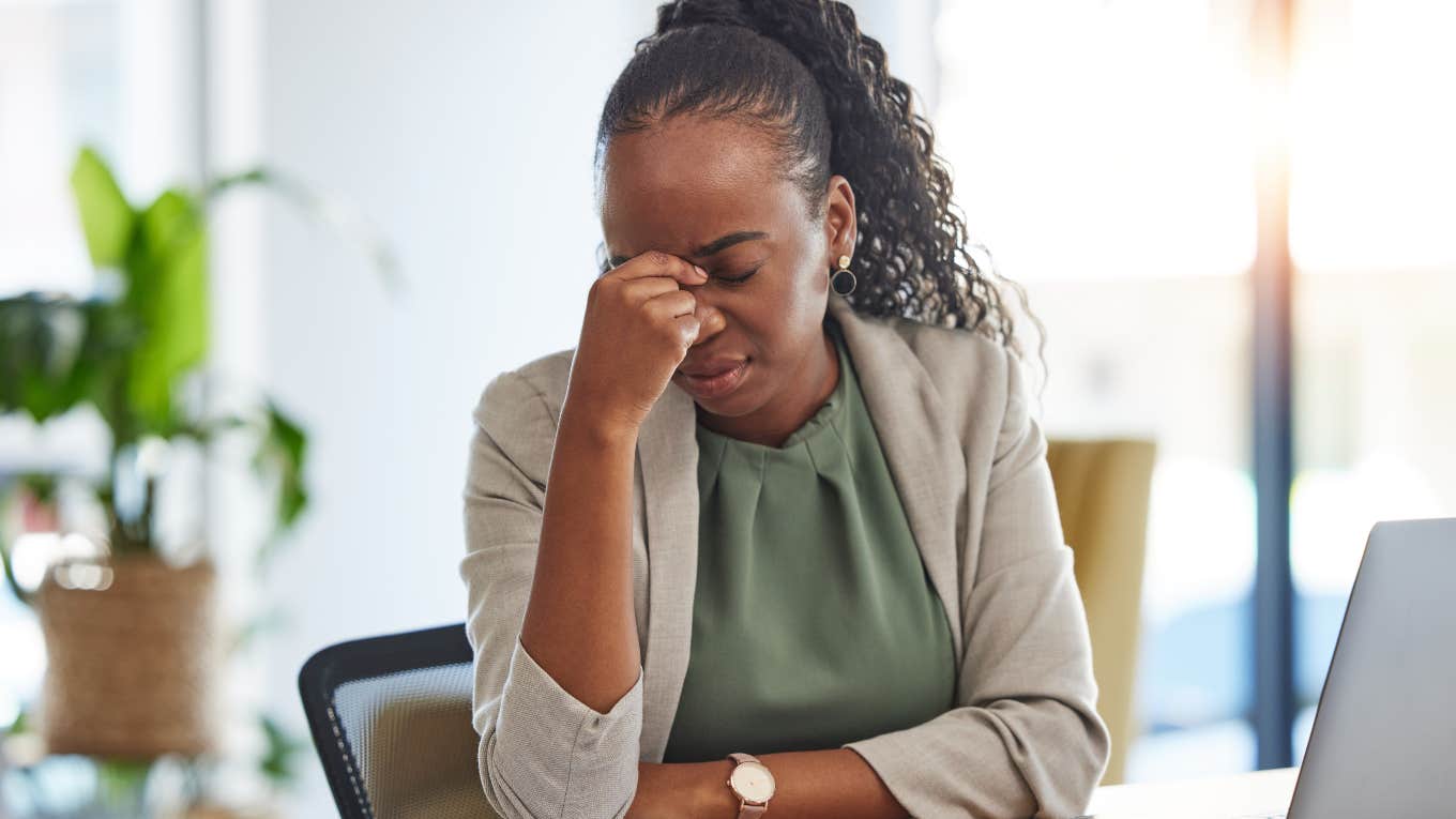 stressed employee sitting at desk at work