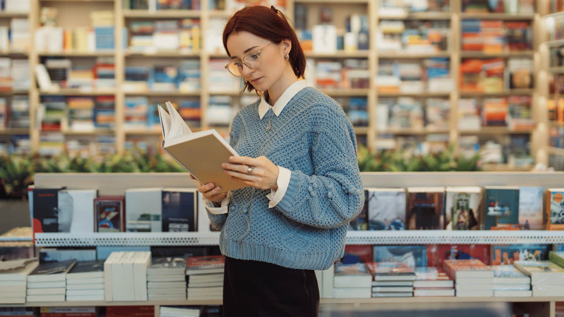 woman reading book in library 