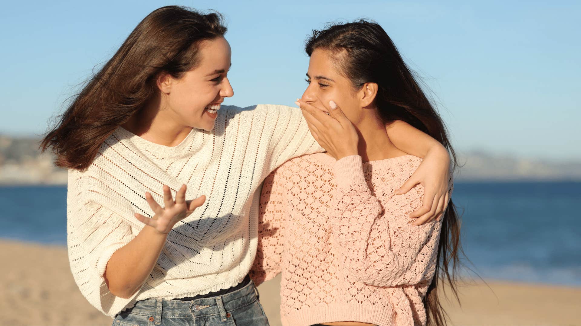 two women talking on the beach 